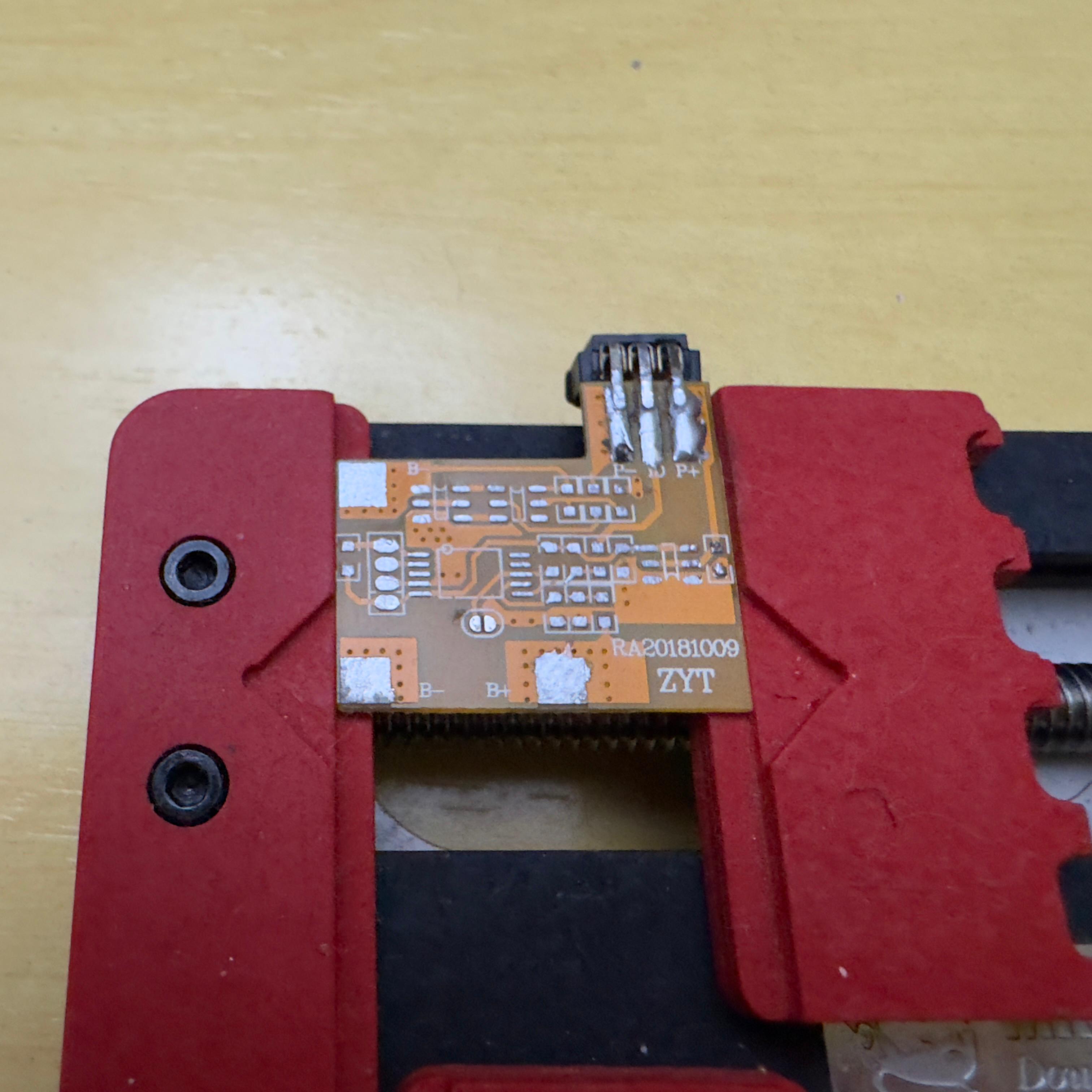 Battery protection PCB with its data pads exposed — front view
