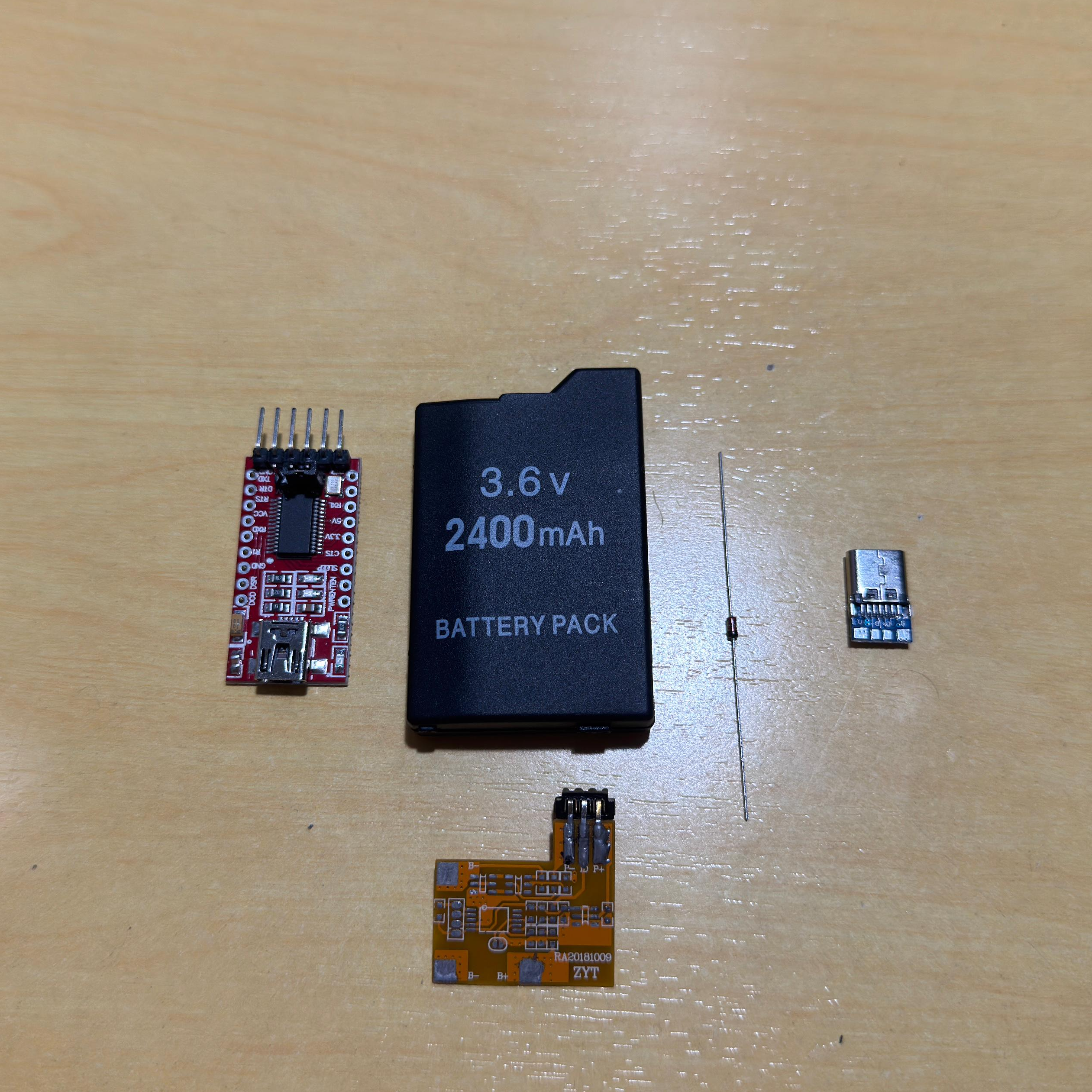 Components laid out — FT232RL, PSP battery donor, 1N4148 diode, USB-C connector, protection PCB